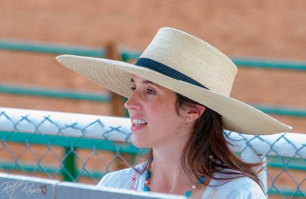 Portrait of a young woman's face at a rodeo event.