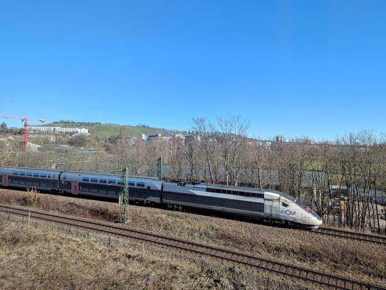 The end of a TGV train descending the Panoramabahn in Stuttgart on a sunny day.