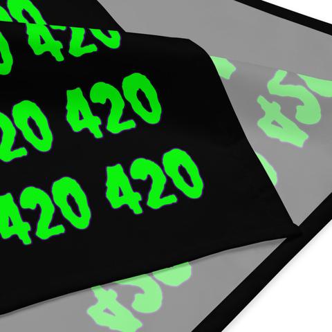 A closeup of the corner of a black bandana with the number 420 in creepy font in a repeating pattern. The numbers are neon green with a purple outline. White background.