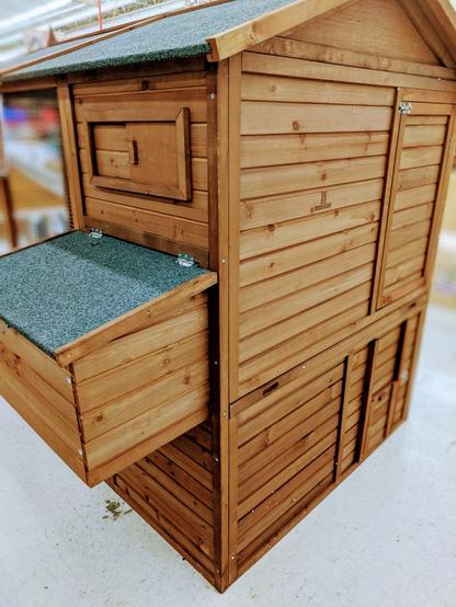 Photo of a full enclosed wooden home, sized for chickens.