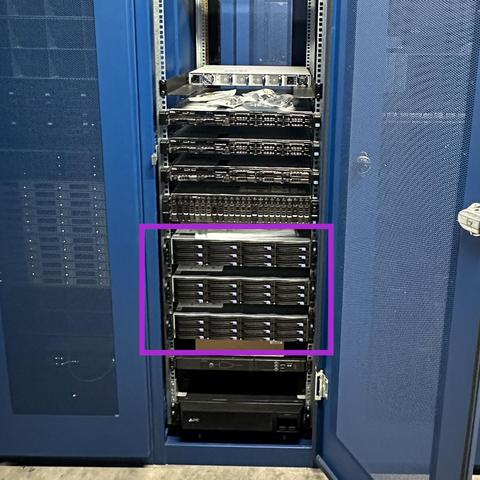 A front view from one of Eva's "HomeLab spill-over into the colo"... server racks, with a pink overlay box indicating the location of three IBM LC-922 Power9 systems. 

Above those are various Dell PowerEdge servers and an Arista DCS-7060CX-32S switch (ports facing rear). 

Located at the base of the rack is an APC UPS and APC ATS, handling automated failover of facility / battery power sources for casually "some-9s of uptime" high-availability compliance.