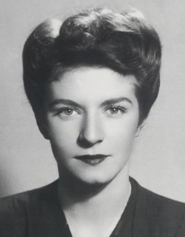 studio photo of Éliane Plewman in civvies. She is a white woman with dark hair.