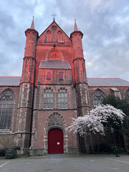 Upper part of church facade glowing red in the setting sun