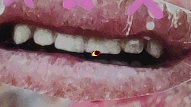 The eye, the main character of the game in front of an image of a mouth with rough dry lips. At the top of the screenshot bright pink paint marker is visible.