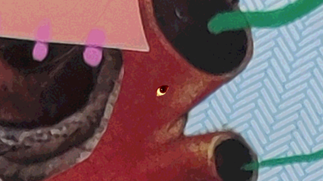 the eye is near threshold of a red form with protruding tubes. From the holes in the tube green paint marker lines flow to the right across a patterned paper you might see inside an envelope.