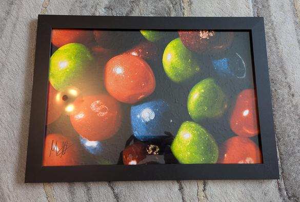 A photo depicting a framed photographic enlargement of a macro photograph of Skittles, shot by Mark on Harman Phoenix 200 colour negative film