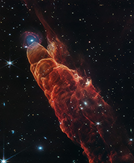 NASA’s James Webb Space Telescope observed Herbig-Haro 49/50, an outflow from a nearby still-forming star, in high-resolution near- and mid-infrared light. The intricate features of the outflow, represented in reddish-orange color, provide detailed clues about how young stars form and how their jet activity affects the environment around them. Like the wake of a speeding boat, the bow shocks in this image have an arc-like appearance as the fast-moving jet from the young star slams into the surrounding dust and gas. A chance alignment in this direction of the sky provides a beautiful juxtaposition of this nearby Herbig-Haro object with a more distant spiral galaxy in the background. Herbig-Haro 49/50 gives researchers insights into the early phases of the formation of low-mass stars similar to our own Sun. In this Webb image, blue represents light at 2.0-microns (F200W), cyan represents light at 3.3-microns (F335M), green is 4.4-microns (F444W), orange is 4.7-microns (F470N), and red is 7.7-microns (F770W). Credit: NASA, ESA, CSA, STScI