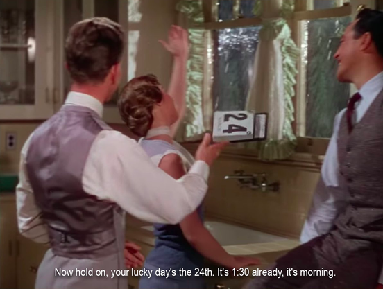 Now the stool man and kitchen table woman are standing by the wink. The stool man is holding the calendar, which now says "24". One of them is saying, “Now hold on, your lucky day’s the 24th. It’s 1:30 already, it’s morning.”