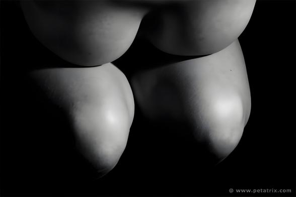 Female nude photography,  torso, breasts are covered, black and white photography, sidelight with pronounced shadows