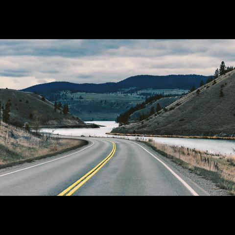 British Columbia landscape in color,with a road, a river and mountain.Canada