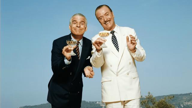 Wearing suave suits, Steve Martin and Michael Caine drink champagne while hunting rich heiresses in the hilltop villas and casinos of the Riviera, in ‘Dirty Rotten Scoundrels’ (1988) Orion Pictures.