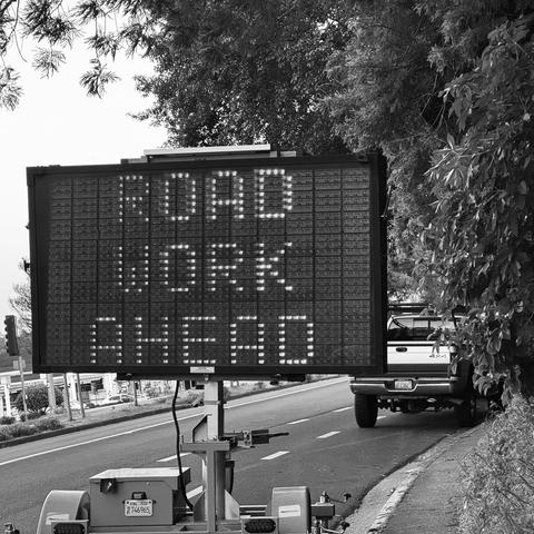 a road work matrix sign saying “road work ahead” in a ‘normal’ style