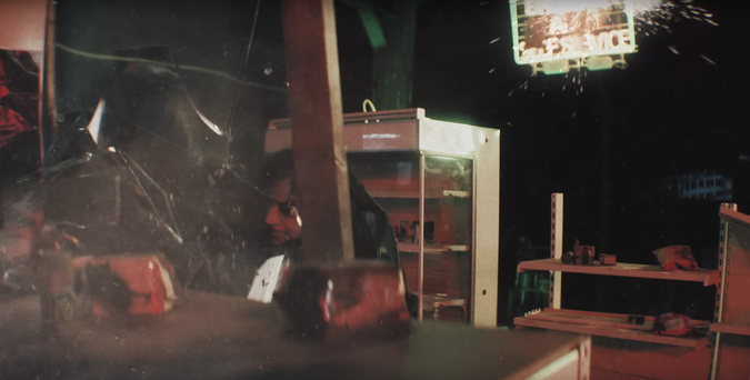 Bang Chan slamming someone, supposedly Hyunjin, up against a glass-fronted display cabinet, and breaking the glass.