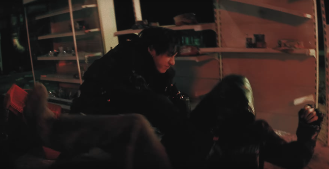 Bang Chan throwing someone who is probably Hyunjin down on a grotty mattress