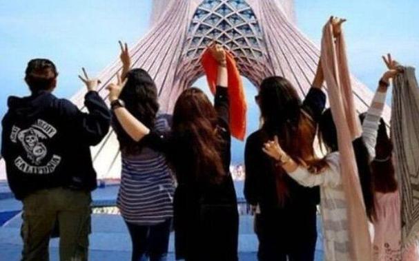 Iranian women in front of the Azadi (Freedom) Tower in Tehran