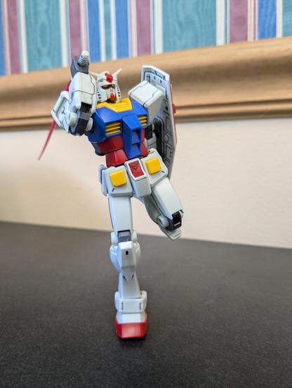 The HG RX-78-2 Revive doing a silly pose while equipped with a beam saber and shield