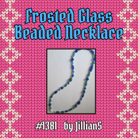 OFMD Craft Fair auction item 1381: Frosted Glass Beaded Necklace, donated by JillianS. A photo shows a necklace of irregularly shaped teal and dark blue beads made from frosted glass that resembles seaglass. They are interspersed with small silver beads.