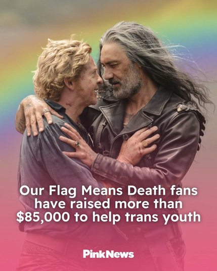 Article graphic from PinkNews’ Instagram post. The headline ‘Our Flag Means Death fans have raised more than $ 85000 to help trans youth’ is written on a photo of Ed and Stede holding each other close and looking into each other’s eyes in the season 2 finale. The background is a soft, blurry rainbow, instead of the beach from the original photo.