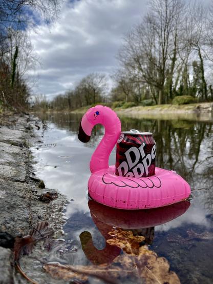 Inflatable flamingo drink holder on a lake