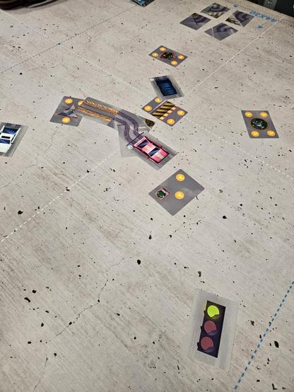 Turbo Drift. Cards depicting cars and various obstacles lay splayed messily on a table.