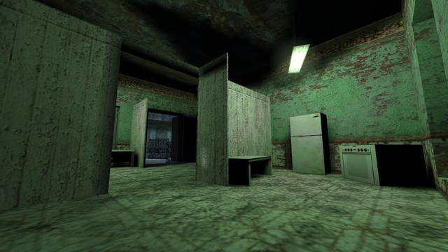 In this picture you can see a room that has been divided into two smaller rooms with a wooden wall. In the middle of the wooden wall is a passageway. On the right side, from left to right, there is a stool, a refrigerator and a stove. Above it, a white-lit lamp hangs from the ceiling. On the left, you can only see another stool and an exit. This is on the map cs_havana in the game Counter-Strike 1.6.