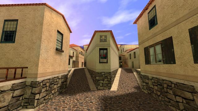 In this picture you can see several houses. To the left and right of the picture, there is also a house. In the middle of the picture is a house, where a path leads off to the left and right. In the background of these two paths you can see other houses. On the right you can see a few stacked wooden boxes, which allows you to get into the open window. Below this is a cove where a yellow-lit lamp hangs on the wall. This is on the map cs_italy in the game Counter-Strike 1.6.