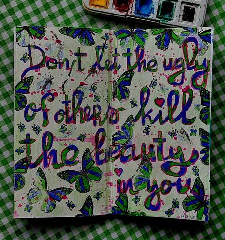 Written quote in blue and green, saying: 

Don't let the ugly of others kill the beauty in you

Butterflies all over the page.