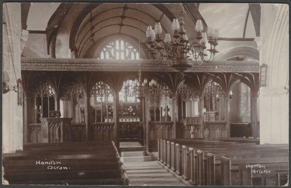 Sepia real photographic postcard showing a view of the interior of St Michael's Church in Honiton, Devon, before the fire of 1911.

Published by Horton, Bristol, not numbered.

Postally used on 25 December 1907 with Bristol machine cancellation on green halfpenny stamp and sent by the publisher C. Horton to Mr Colborne, Downend Road, Fishponds, Bristol.

Good condition, with slight corner bumps, some wear to bottom corners and heavy cancel.