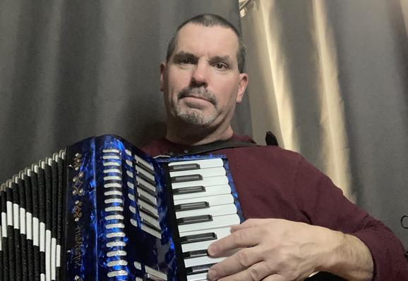 Photo of the post author, Brian Kelley, playing accordion.