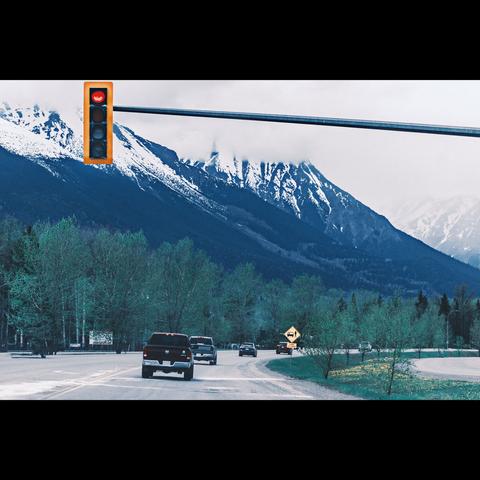 British Columbia landscape in color,with a road, a traffic light and mountain.Canada
