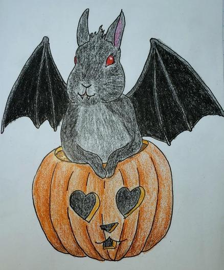 A dark grey bunny with a grey tummy, black bat wings, and red eyes sits in a jack o'lantern with heart eyes and a bunny nose and mouth.