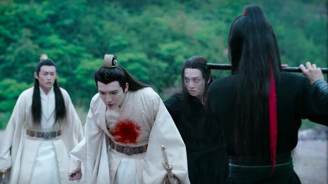 In an open outdoors area, trees in the distance, Jin Zixun stands shocked as Jin Zixuan is attacked from behind by an out of control Wen Ning. Red blooms across the front of Zixuan's robes and drips from his mouth. Wei Wuxian stands in the foreground, shown from behind, the dizi Chenqing still raised to his lips.