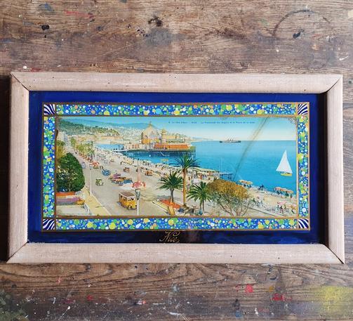 A partially restored 1930s souvenir from Nice France featuring a hand coloured print of the Promenade des Anglais
