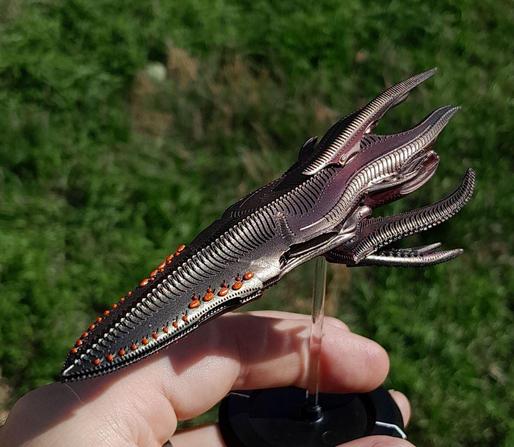 miniature alien spaceship, organic, green and purple, kinda like a spur, with orange dots
