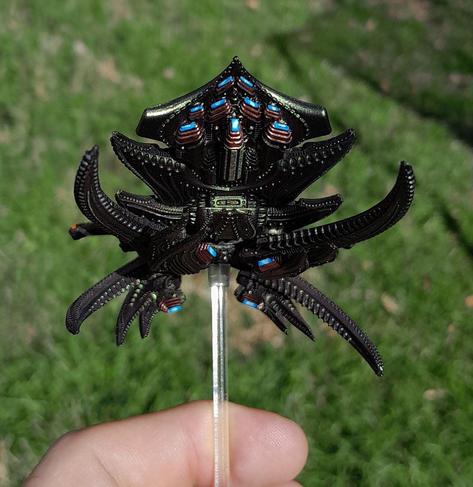 miniature alien spaceship, organic, seen from below to show off the blue glow of the engines against coppery accents