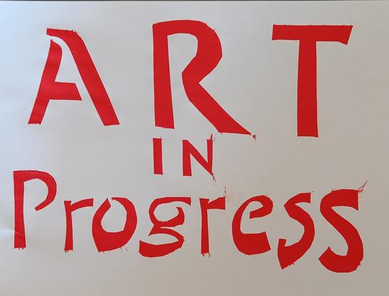 "Art in Progress" in big red letters on white paper. Bridges in the letters A o and g hint at the stencil cut lettering