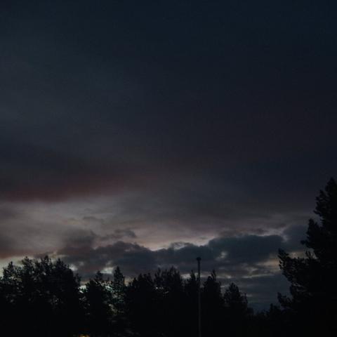 Some dark blue and reddish clouds giving way to the dawnbreak in the winter.