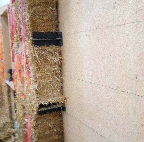 Bales mounted on a wall with a straw bale anchor.