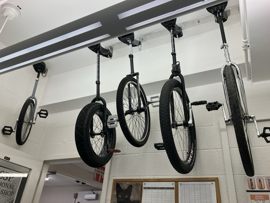 5 unicycles hanging from my office ceiling.