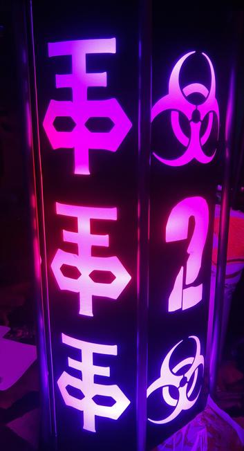 A photography of a lantern, glowing in tones of purple and having some obscure symbols on it.