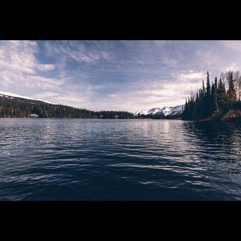 Photo of a landscape in color, a lake with mountain in the skyline, Yukon territory , Canada
