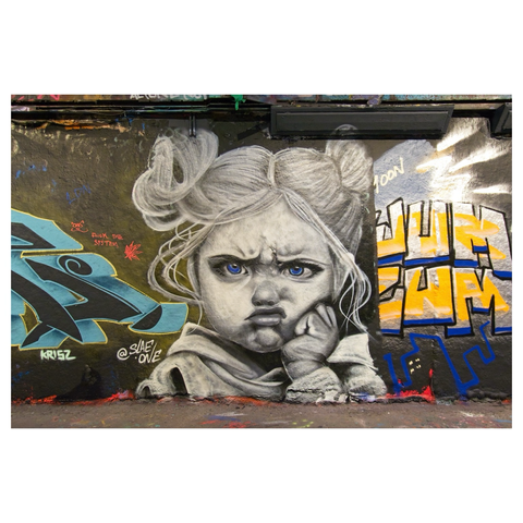 Photo of amazing streetart of a pouting child in the Leake Street Arches