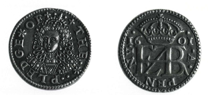 two sides of a silver coin : the front with a portrait of the queen and "PLEDGE OF THE"
the back with a monogram, and PENNY 1601