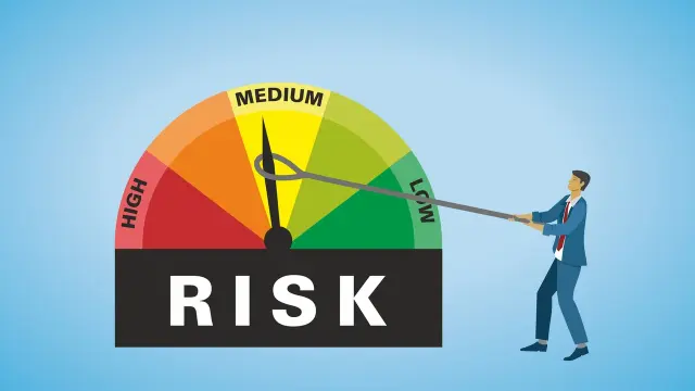 A cartoon of a person trying to reduce risk, by pulling a clockface arm from medium to low.