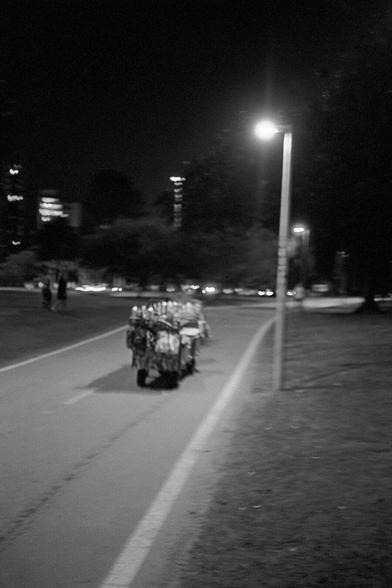 Vendor leaving Praia do Flamengo, night photography black and white
