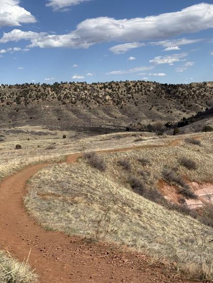 Winding red gravel trail near Red Rocks Park, Morrison, Colorado.