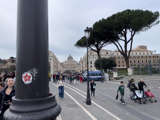 The AntiFascist Fediverse sticker stuck on a pole in front of San Pietro, in Vatican City (Rome)