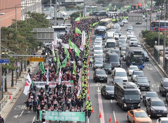 A large crowd holding banners march
