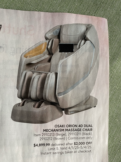 Text below chair reads: OSAKI ORION 4D DUAL MECHANISM MASSAGE CHAIR Item 2910213 (Beige), 29110211 (Black), 2910212 (Brown) | Costco.com only $4,899.99 delivered after $2,000 OFF Limit 5. Valid 4/1/25-5/4/25. Instant savings taken at checkout.