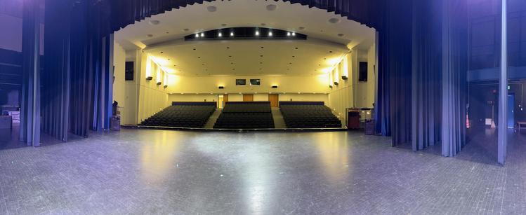 Panorama of a theatre, from the stage towards the house. The room is empty.